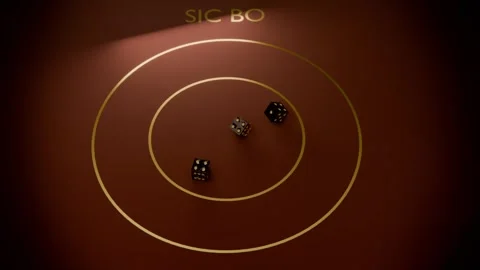 Tossing three black dice tumbling on maroon Sic Bo table, spotlight guiding Stock Footage 340268358