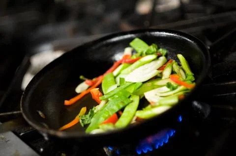 Tossing vegetables Stock Photos
