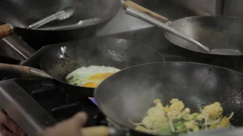 Tossing vegetables in wok Stock Footage 77986456