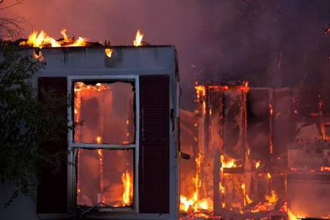 Total destroyed house arson fire night Stock Photos
