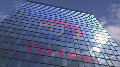 TOTAL logo on modern building reflecting sky and clouds, editorial 3D rendering Stock Illustration