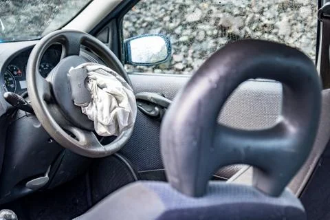 Total loss car with exploded airbag and broken windscreen Stock Photos
