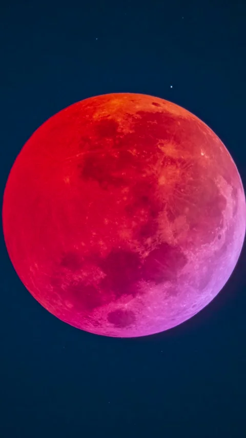 Total Lunar Eclipse Blood Moon showing red and purple hues over Santiago, Chile Stock Footage 334217488