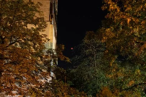 A total lunar eclipse over the city of Dnipro in Ukraine, a night sky with a  Stock Photos