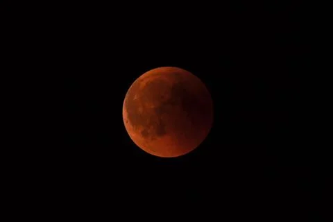 A total lunar eclipse with a reddish moon against a dark sky, Haan, North Stock Photos