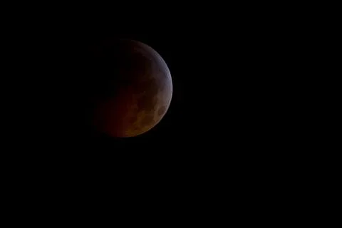 A total lunar eclipse is seen as the full moon is shadowed by the Earth on .. Fotos Stock
