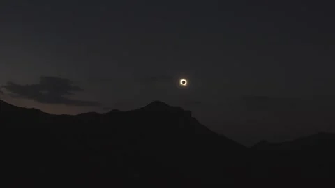 Total solar eclipse above mountain silhouettes at Saliencia Lakes in Somiedo Stock Footage 347916203