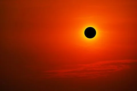 Total solar eclipse on clear red orange sky sunset in the evening Stock Illustration