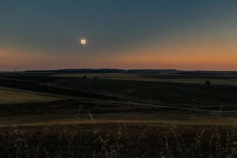 Total solar eclipse creating diamond ring over agricultural landscape in Spain Stock Photos