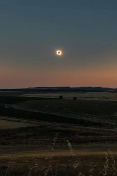 Total solar eclipse illuminating the sky over a vast rural landscape in Spain Stock Photos