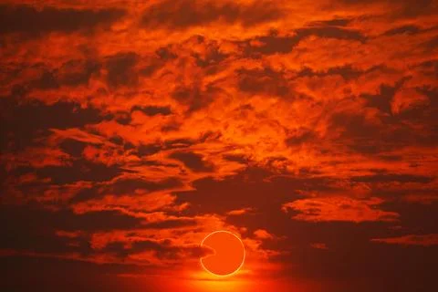 Total solar eclipse on red orange sky sunset in the evening Stock Photos