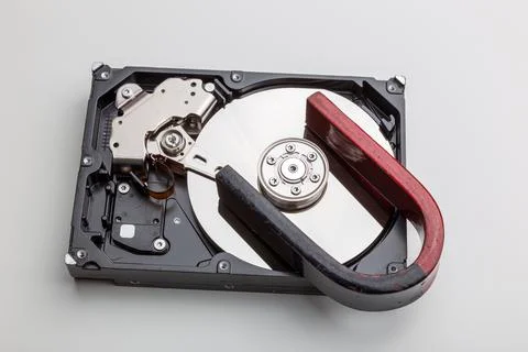 Total wiping of data on the hard drive with a magnet Stock Photos