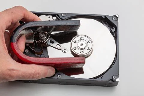 Total wiping of data on the hard drive with a magnet Stock Photos