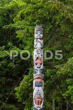 Totem Pole on Evergreens Stock Photos
