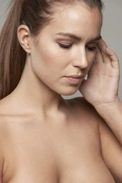 Touch, beauty and serious face of woman in studio for wellness, facial treatment Stock Photos