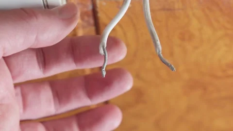 Touch electrical wires without insulation with your hands. Electric shock h.. Stock-Footage 292758843