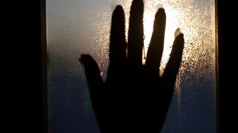 To touch the hand to drop on the glass against the backdrop of a beautiful Stock Footage