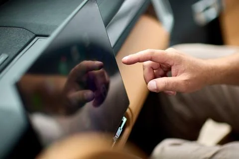 Touch interface controls vehicle features. Driver uses touchscreen to manage car Stock Photos