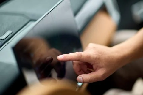 Touch interface controls vehicle features. Driver uses touchscreen to manage car Stock Photos