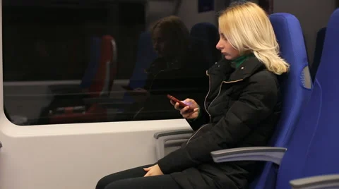 Touch phone sms writing, young woman in train Stock Footage 60115262