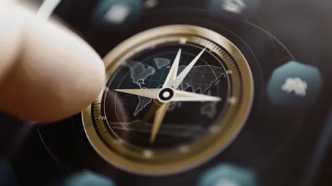 Touch rotates compass across global estate map Stock Footage 346605800