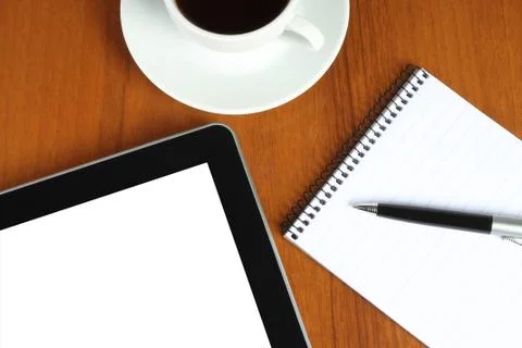 Touch screen device, notepad, pen and cup of coffee Stock Photos