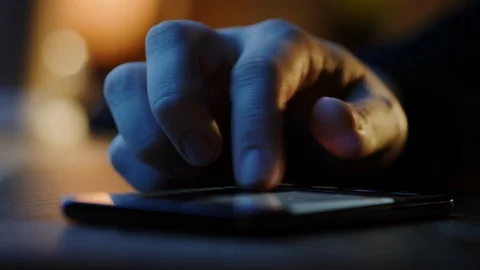Touch Screen Smartphone Lying on Table while Person Scrolls through Social Media Stock Footage 121796471
