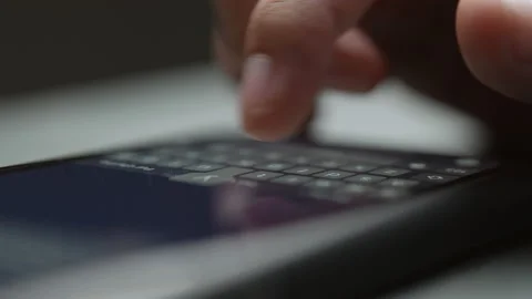 Touch Screen Smartphone Lying on the Table while Person is typing a Message Stock Footage 154314099