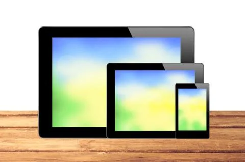 Touch Screen Tablets with bright screen on wooden table isolated on white Stockfoto's
