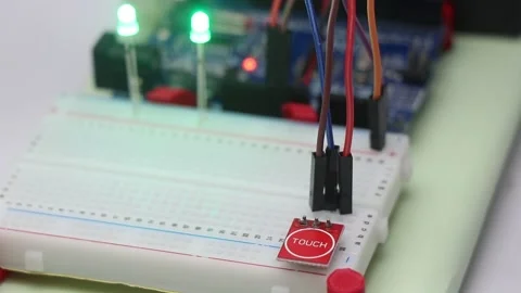 Touch sensor controlling the green led when it is touched the led turns on Stock Footage 321893200