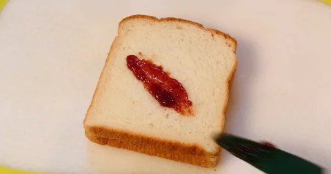 Touch with strawberry jam on bread Stockbeeldmateriaal 162602753
