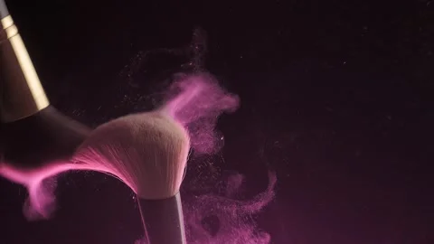 From the touch of two makeup brushes, colorful glittering powder or blush Stock Footage 194395611