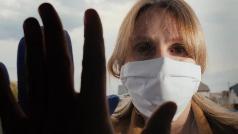 Touch your hands through the glass during quarantine and insulation Stock Footage 128456835