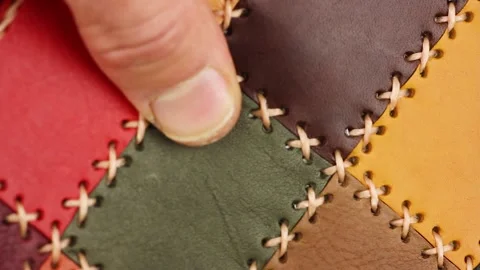 Touches multi-colored patchwork leather with large stitching, quality test Video stock 156474633