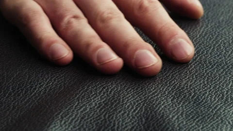 Touching black leather with hand close-up, production handmade accessories made Stock-Footage 157374641
