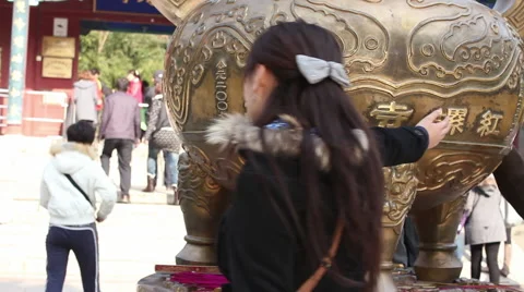 Touching Buddhist incense burner for luck Stock Footage 54150335