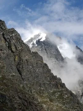 Touching the clouds, where rugged rocks meet icy heights. Stock Photos