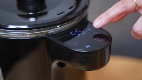 Touching Digital Control Panel on Modern Kettle Stock Footage 335958909