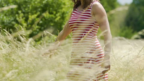 Touching field crop with hand in fall autumn, young woman feels touch of nature Stock Footage 96716839