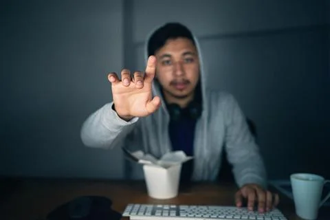 Touching the future. a young man using an unseen digital interface while sitting Stock Photos