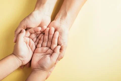 A touching gesture captured in a studio top view shot, family hands stacked.. Foto stock
