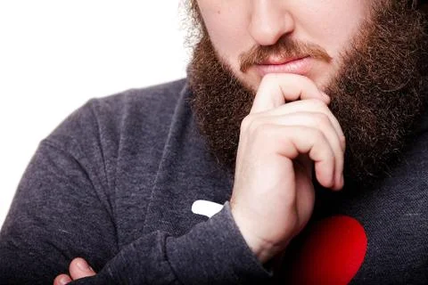 Touching his perfect beard. Close-up of young bearded man touching his beard Foto stock