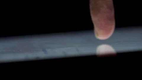 Touching IPad Computer At The Dark. Extreme close up of finger typing on Stock Footage 85020452