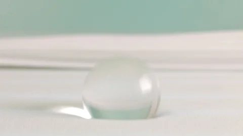 Touching a memory foam bed with a glass ball Stock Footage 91735379