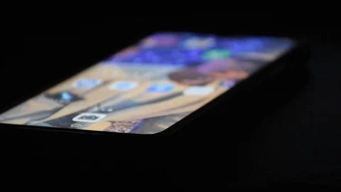 Touching the mobile phone at night time Stock Footage 128812576