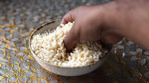 Touching or mixing puffed rice Stock Footage 332688793
