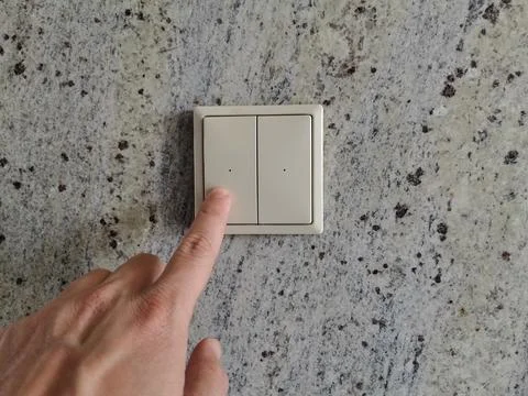Touching the power button. Turning the lights on, off. Stock Photos