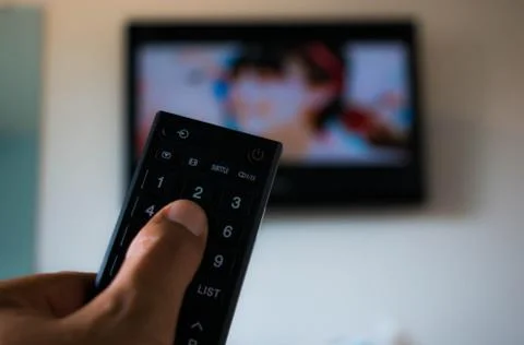 Touching remote television Stock Photos