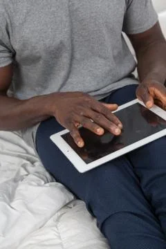 Touching the screen of his tablet. Stock Photos