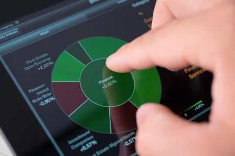 Touching screen of tablet pc with market graph Stock Photos